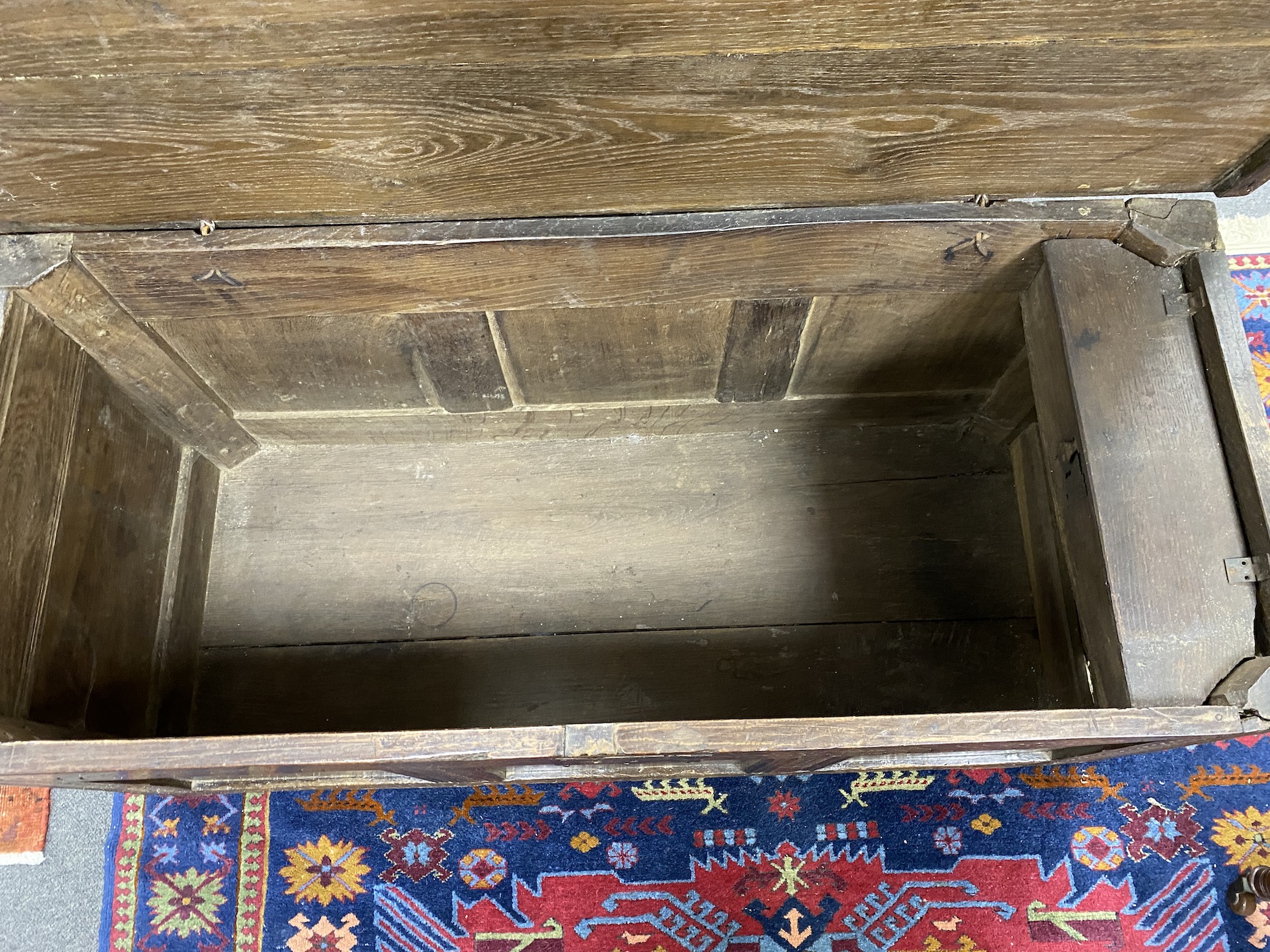 A large carved oak panelled coffer, length 131cm, depth 54cm, height 56cm